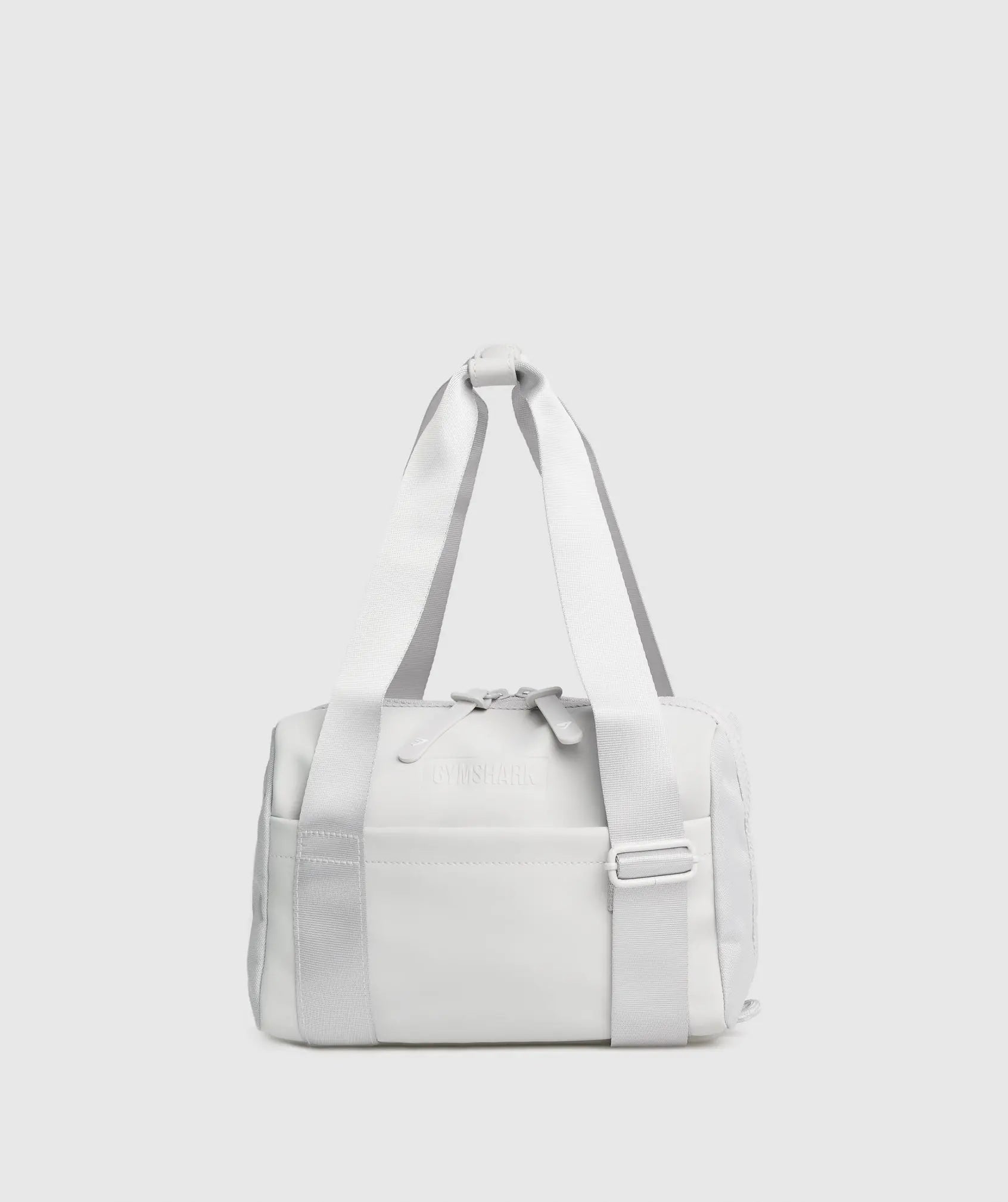 حقيبة يد صغيرة بيضاء على خلفية رمادية SAUDI SHARK Everyday Mini Holdall.
