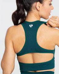 المنظر الخلفي لامرأة ترتدي حمالة صدر رياضية بدون خياطة BEST Move للنساء بلون Smaragd Green Solid.