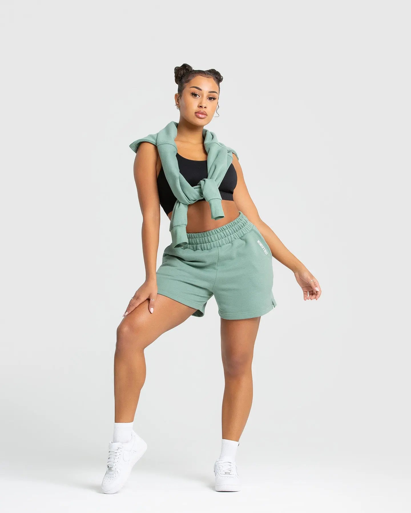وصف: المرأة ترتدي كنزة صوفية من WOMEN'S BEST Green الفاتح وشورت Comfort Shorts.
