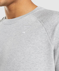 رجل يرتدي سويت شيرت كريست مريح من Gymshark | United We Sweat مع شعار أبيض أنيق.