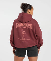 وصف: امرأة ترتدي هودي "Committed To The Craft" من ماركة "Gymshark | United We Sweat" فرانسيسكو زي، الذي يجم